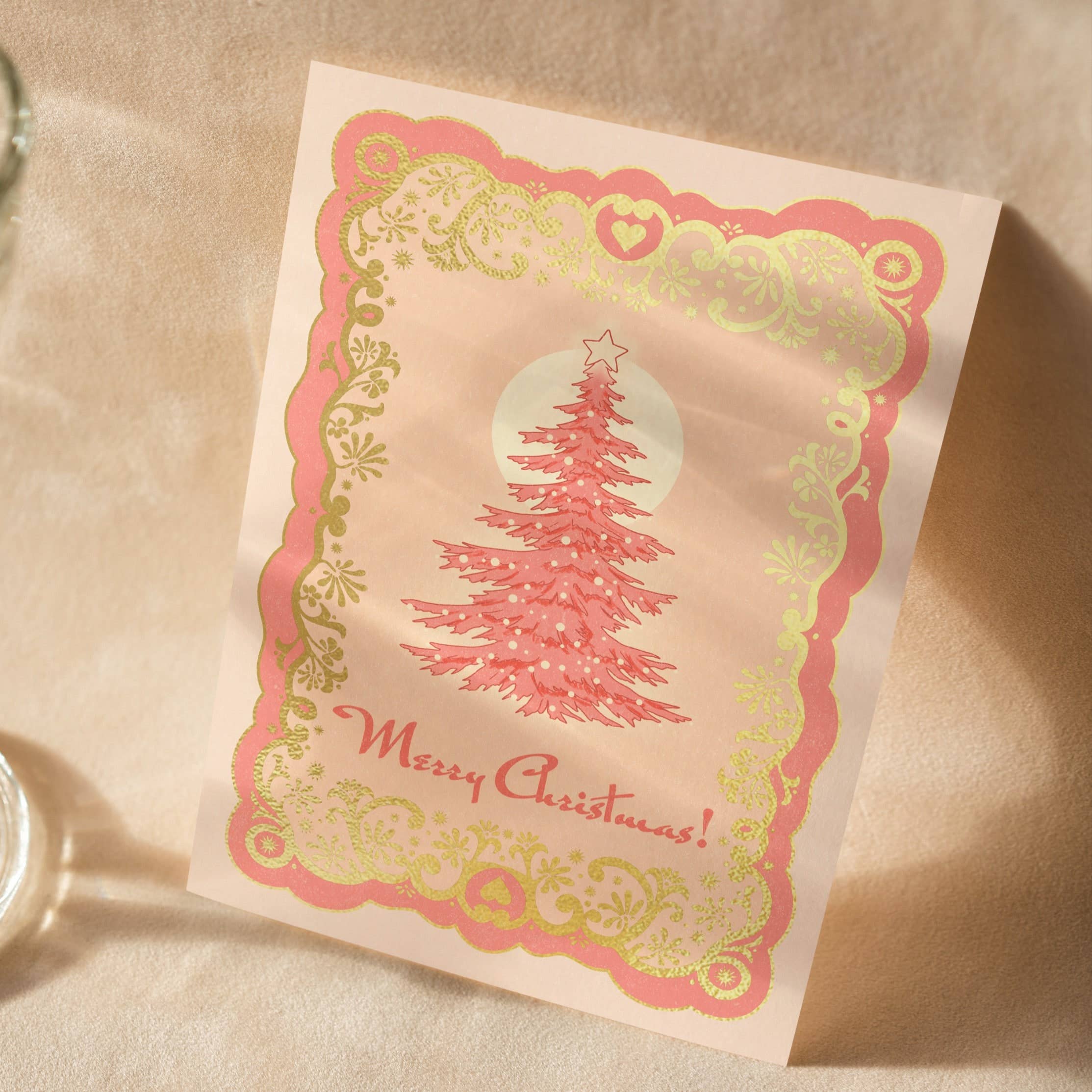 A6 handmade eco-conscious card with soft pink hues and luxe gold foil detailing, featuring a Christmas tree design. Includes a Kraft envelope and biodegradable cello wrap.