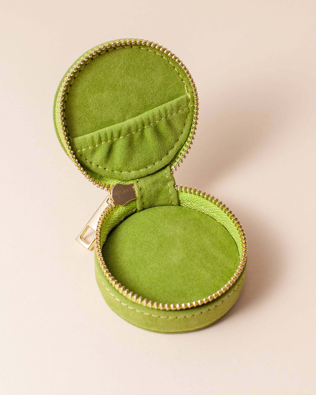 Avocado green velvet polyester mini travel jewellery case with a zip closure and a sun embroidery. Perfect for travel and jewellery storage.