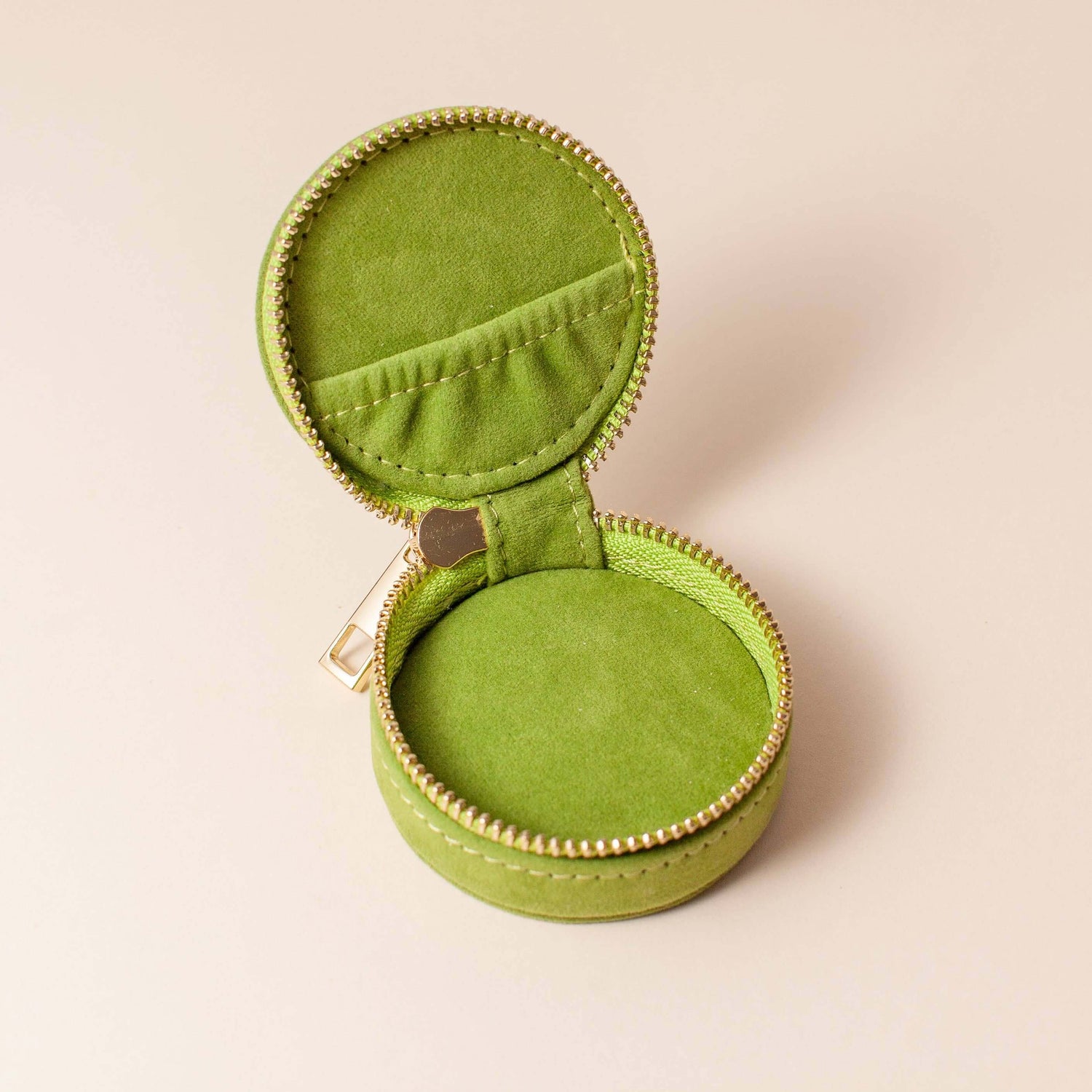 Avocado green velvet polyester mini travel jewellery case with a zip closure and a sun embroidery. Perfect for travel and jewellery storage.