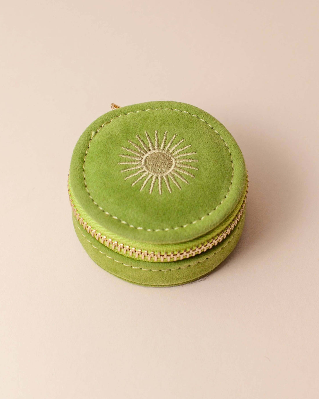 Avocado green velvet polyester mini travel jewellery case with a zip closure and a sun embroidery. Perfect for travel and jewellery storage.