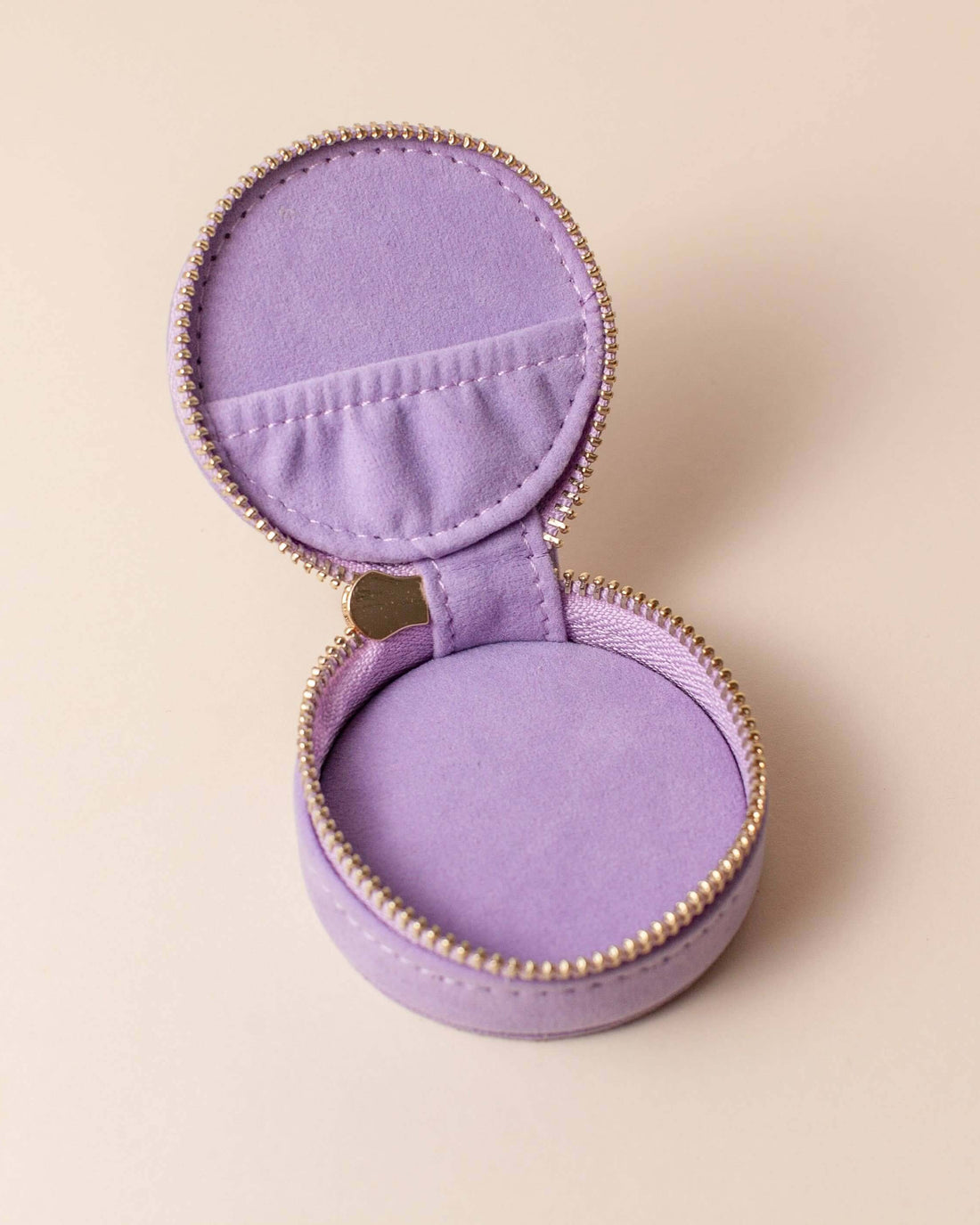 Open lavender velvet polyester mini travel jewellery case with a zip closure and an embroidered sun design. Ideal for travel and jewellery storage.
