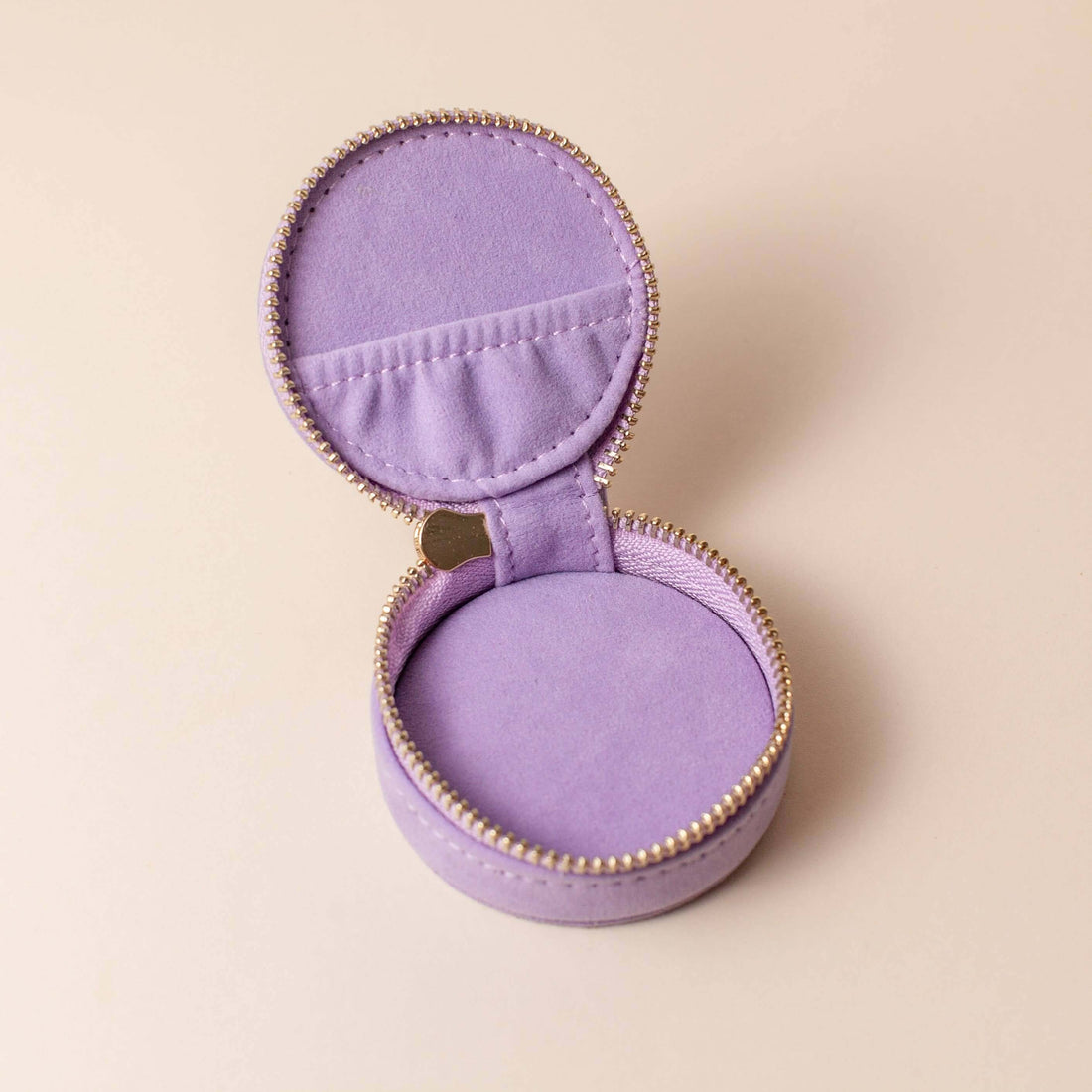 Open lavender velvet polyester mini travel jewellery case with a zip closure and an embroidered sun design. Ideal for travel and jewellery storage.