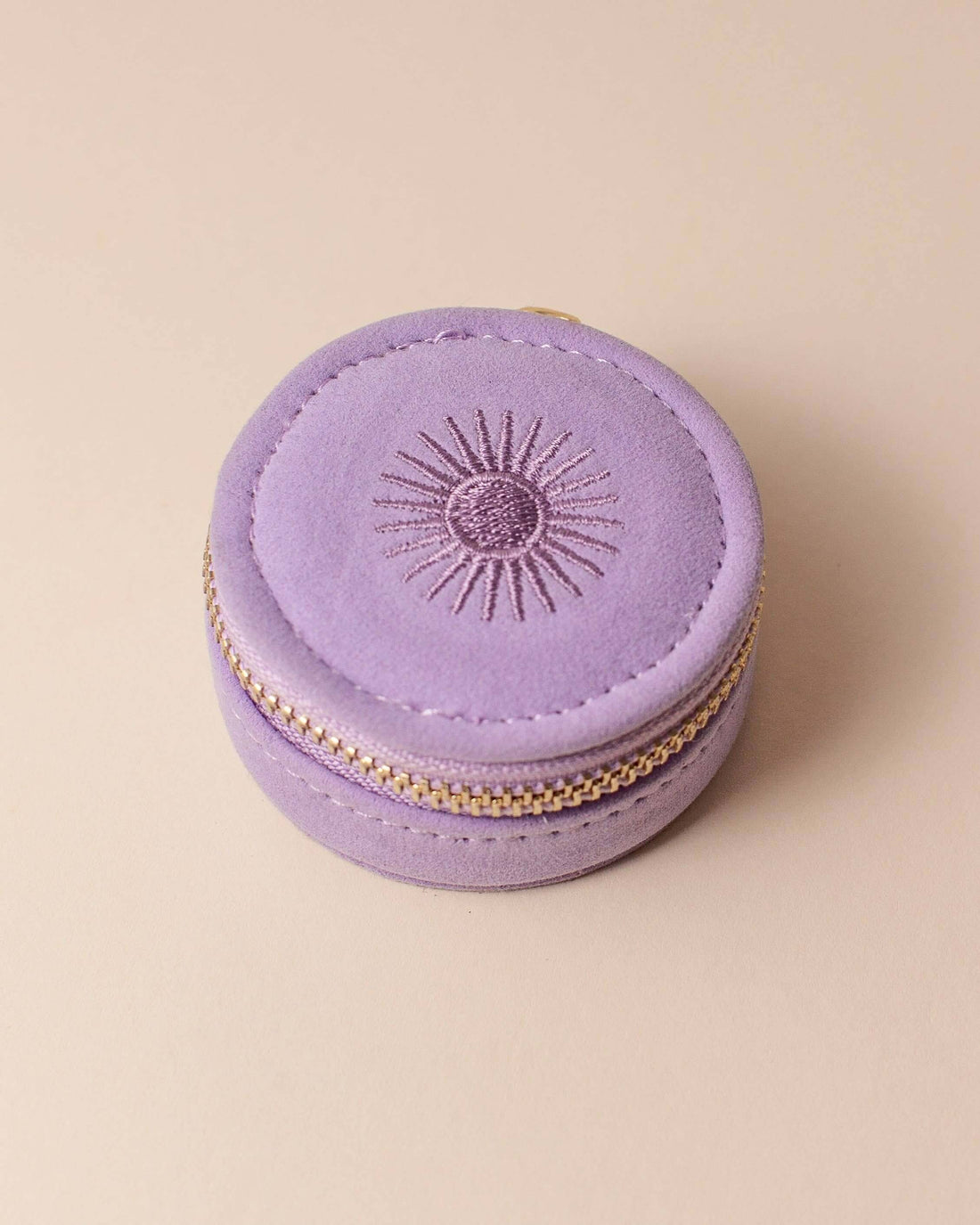 Lavender velvet polyester mini travel jewellery case with a zip closure and an embroidered sun design. Ideal for travel and jewellery storage.