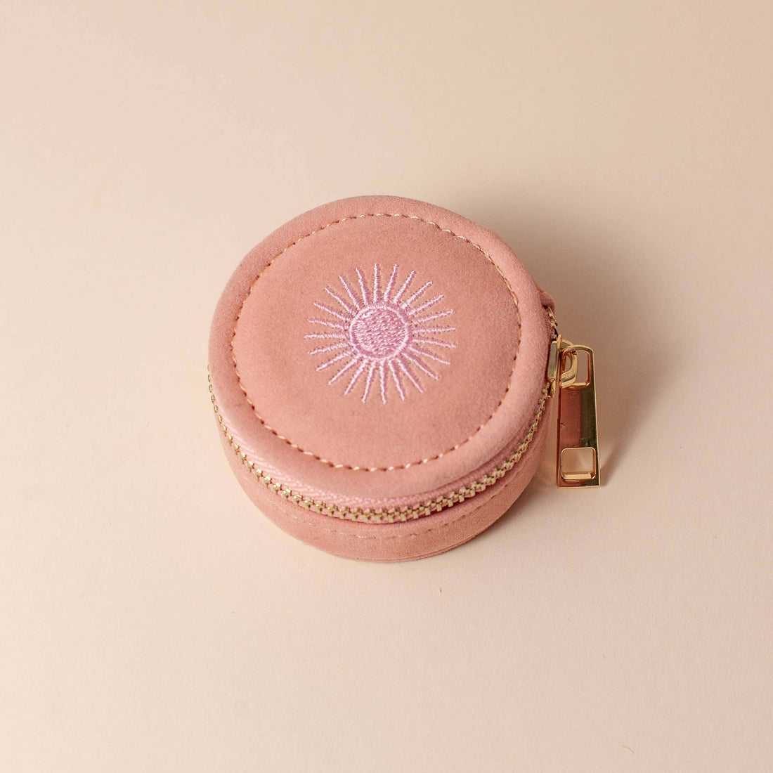 Dusty pink velvet polyester mini travel jewellery case with a zip closure and sun embroidery. Ideal for jewellery storage and travel.