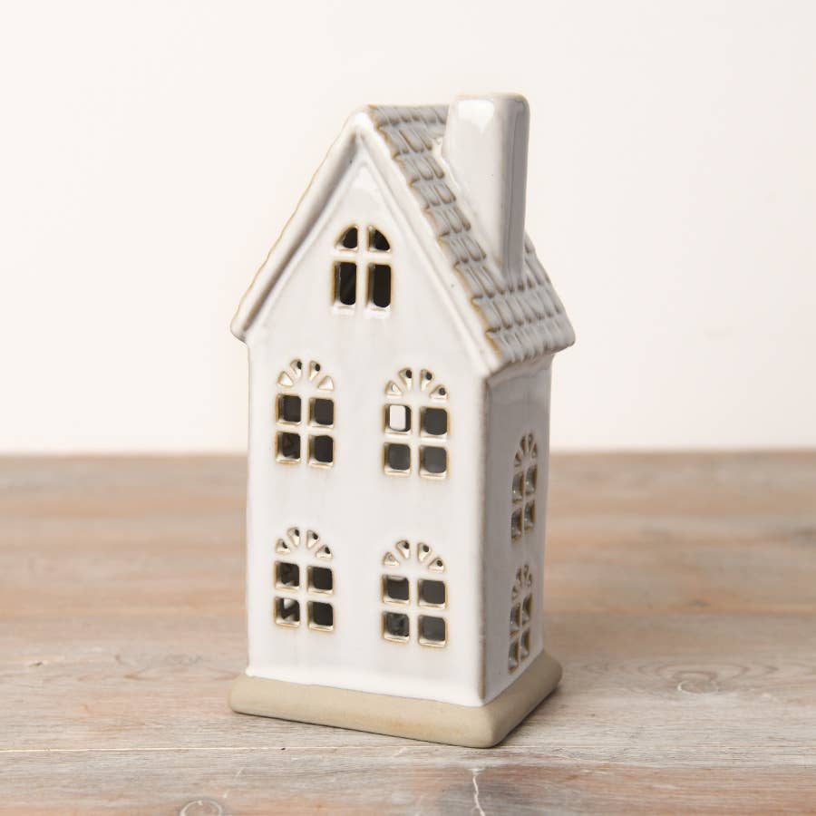 Hand-finished ceramic LED house with a textured roof and natural reactive glaze. Perfect for Christmas décor.