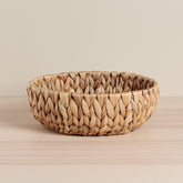 Handcrafted round bowl made from sustainable water hyacinth. A stunning eco-friendly home décor piece.