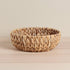 Handcrafted round bowl made from sustainable water hyacinth. A stunning eco-friendly home décor piece.