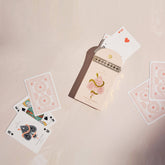 Premium-grade playing cards in pale pink with a gold-foiled tuck box featuring an ace of spades design with a snake wrapped around it. Perfect for games and gifting.