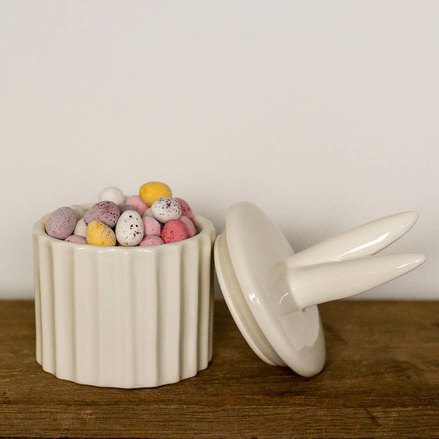 Ceramic storage pot featuring cute bunny ears. A delightful Easter décor piece.