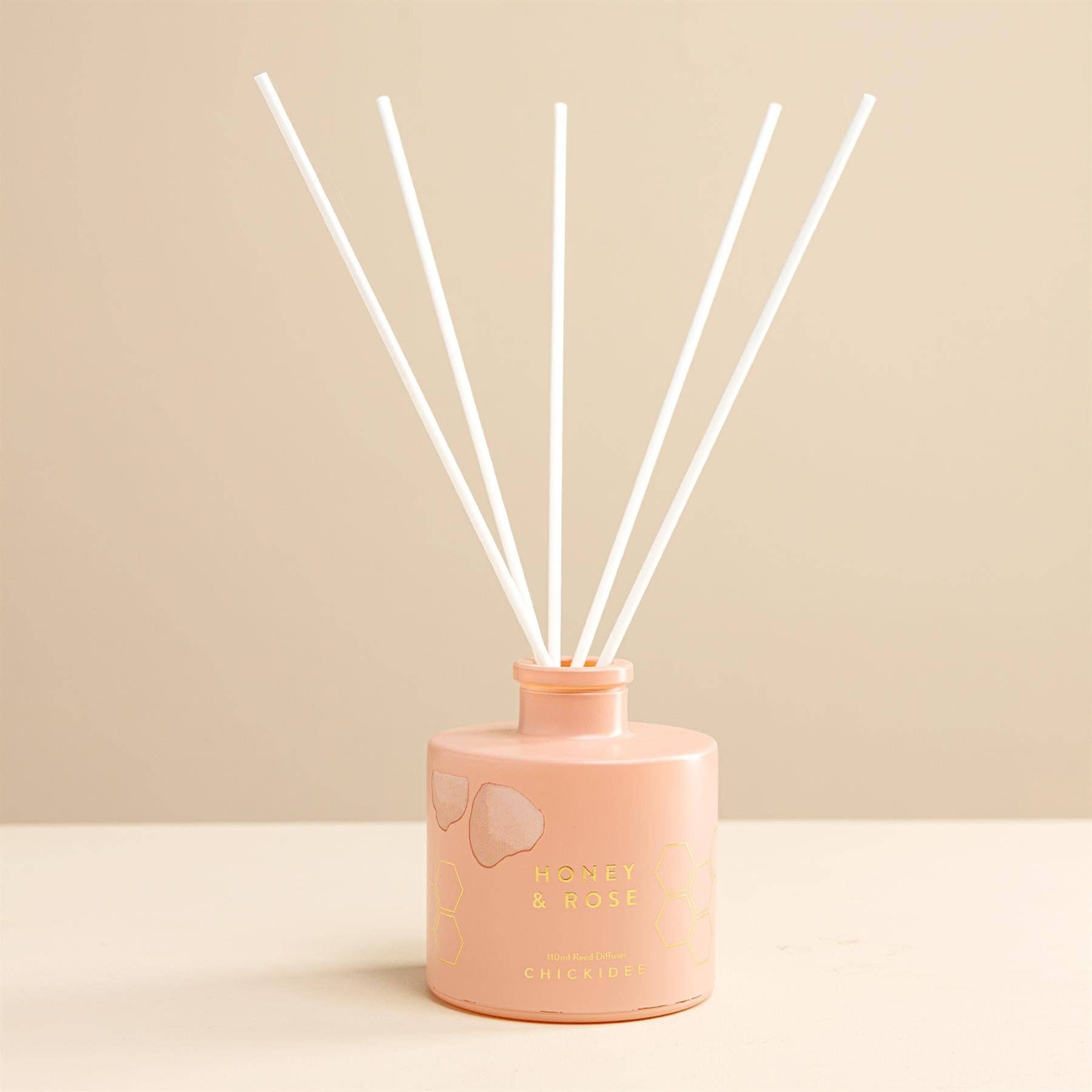 Handcrafted reed diffuser with natural botanicals and premium fragrance oils in a Honey &amp; Rose scent.