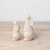 Standing ceramic bunny with a ribbed reactive glaze finish in white/cream. Ideal for Easter or spring décor.