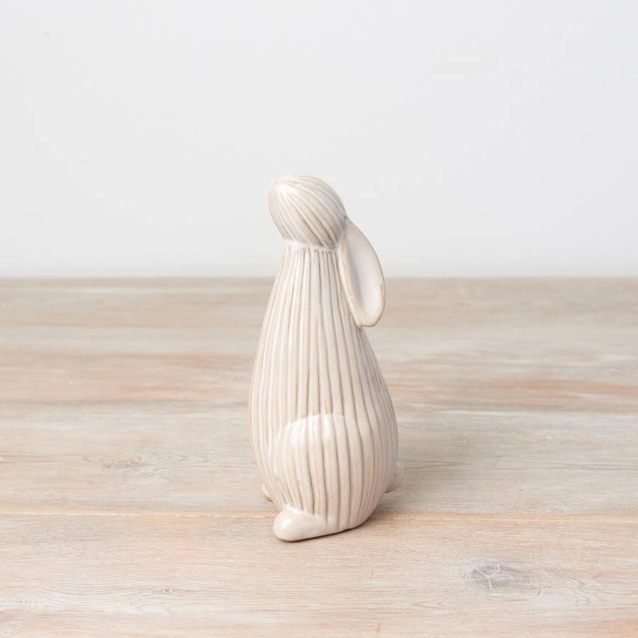 Standing ceramic bunny with a ribbed reactive glaze finish in white/cream. Ideal for Easter or spring décor.