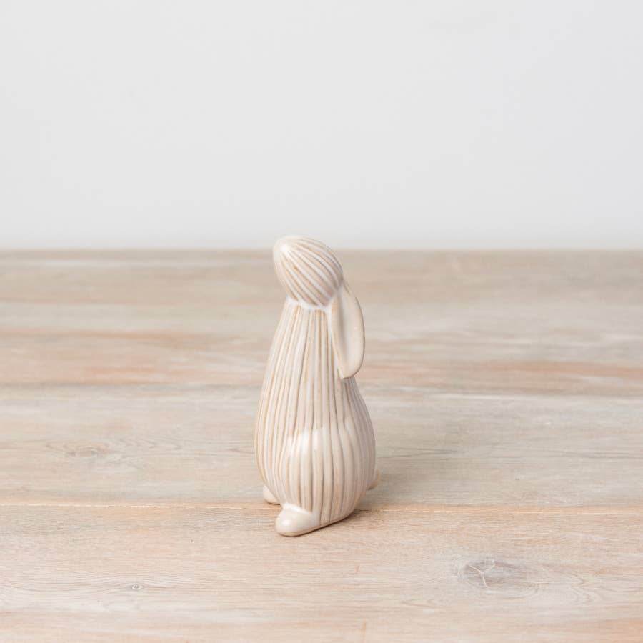 Standing ceramic bunny with a ribbed reactive glaze finish in white/cream. Ideal for Easter or spring décor.