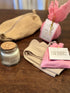 Self-care gift box with an organic waffle pouch, luxury bath bomb, self-love crystals, and cosy cotton socks. A relaxing and thoughtful gift idea.