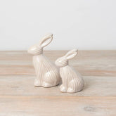 Sitting ceramic bunny with a ribbed reactive glaze finish in white/cream. A charming Easter or spring décor item.