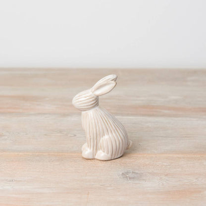 Sitting ceramic bunny with a ribbed reactive glaze finish in white/cream. A charming Easter or spring décor item.