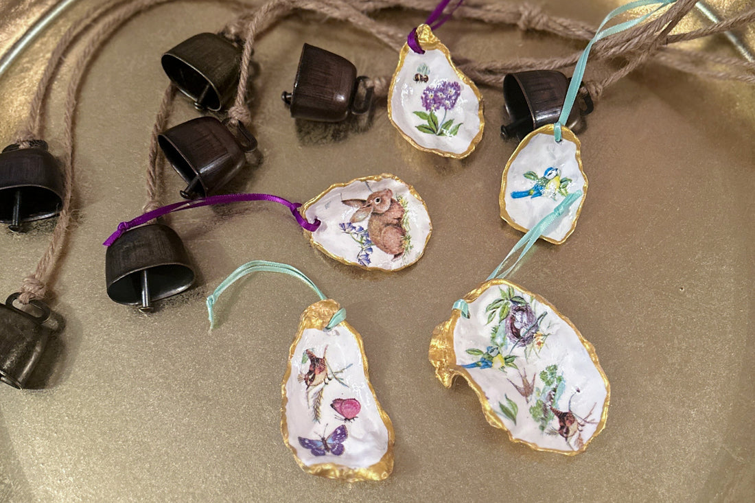 Set of five handmade Easter hanging ornaments crafted from oyster shells, featuring a decoupage technique with hand-painted gold edges, decorated with spring motifs like bunnies, flowers, and bees, perfect for Easter or spring decor.