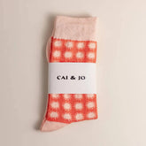 Orange socks featuring an all-over sunshine design. Made from 75% cotton for comfort, one size fits most. In packaging