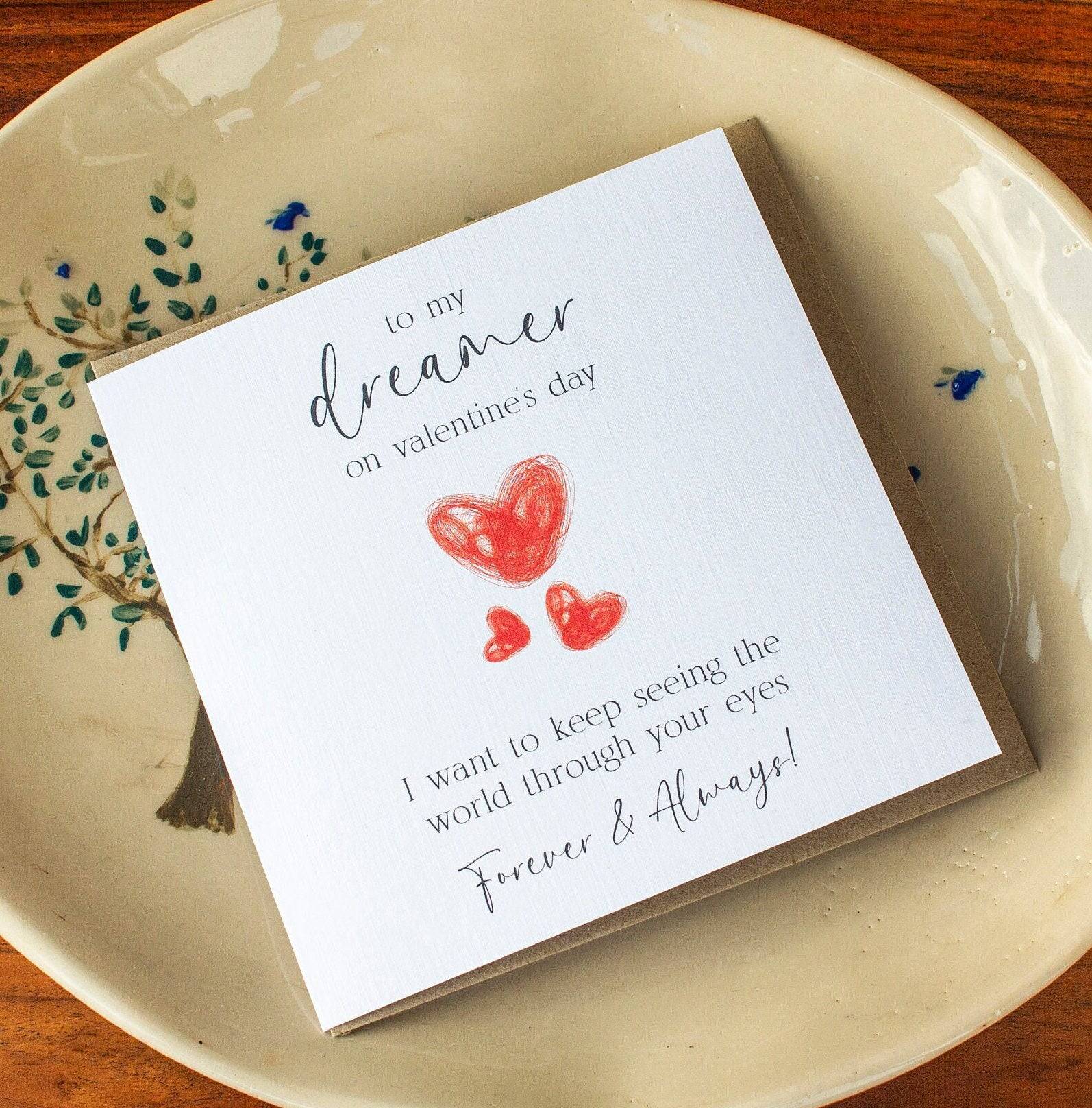 Handmade Valentine’s Day card featuring three red hearts and the text: &quot;To my dreamer on Valentine’s Day, I want to see the world through your eyes forever and always.&quot;