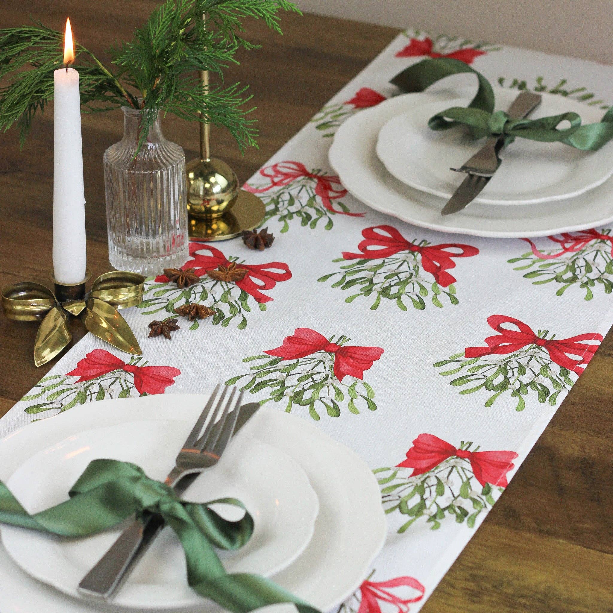 Cream table runner made from pure cotton, featuring red bows and mistletoe design.