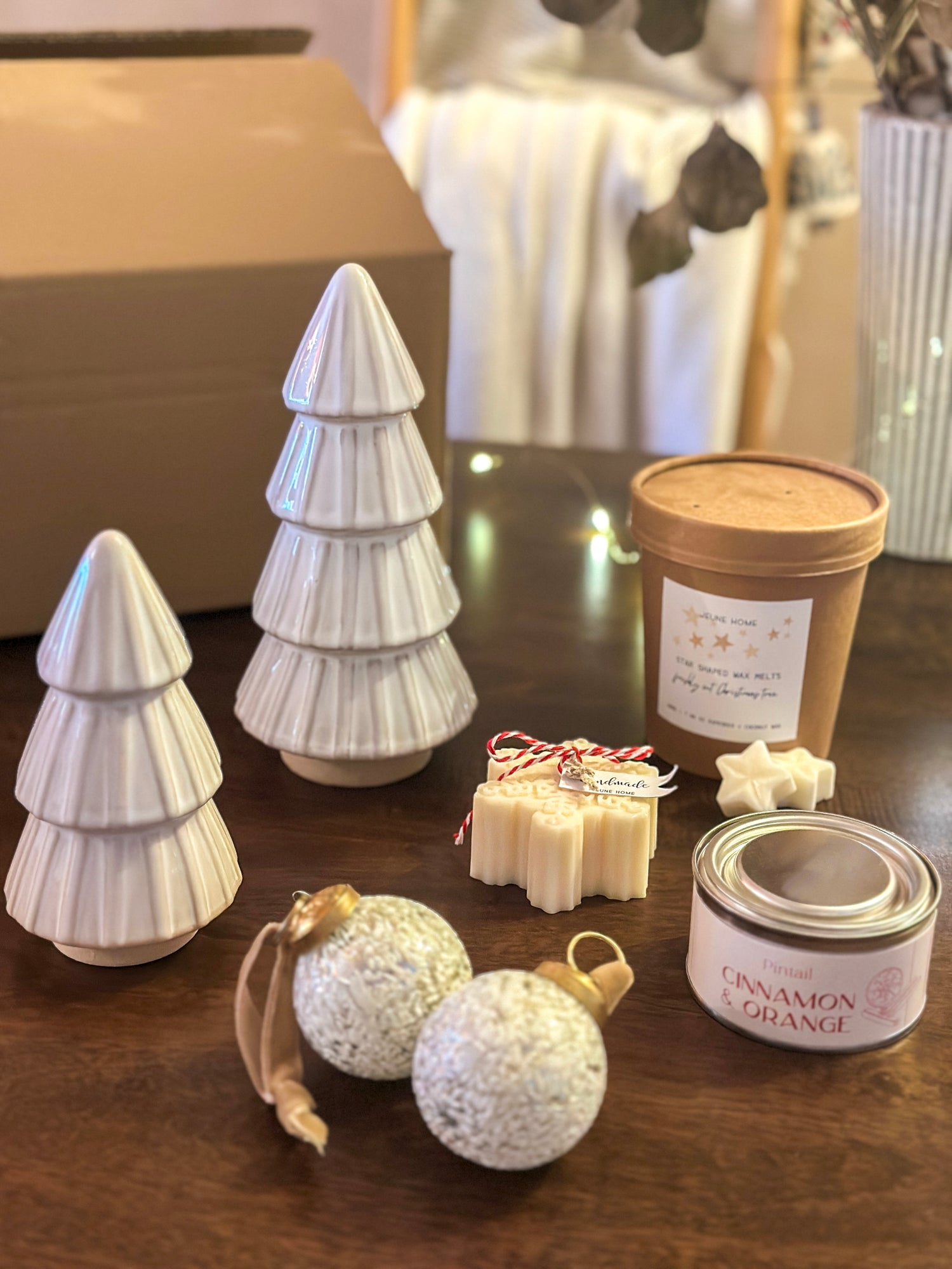 Gift box containing white reactive glaze tree ornaments, textured baubles, cinnamon orange candle, and scented wax melts. Perfect for Christmas gifting.