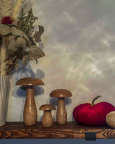 Mango wood mushroom ornament with a smooth, natural finish. A rustic addition to your autumn décor.